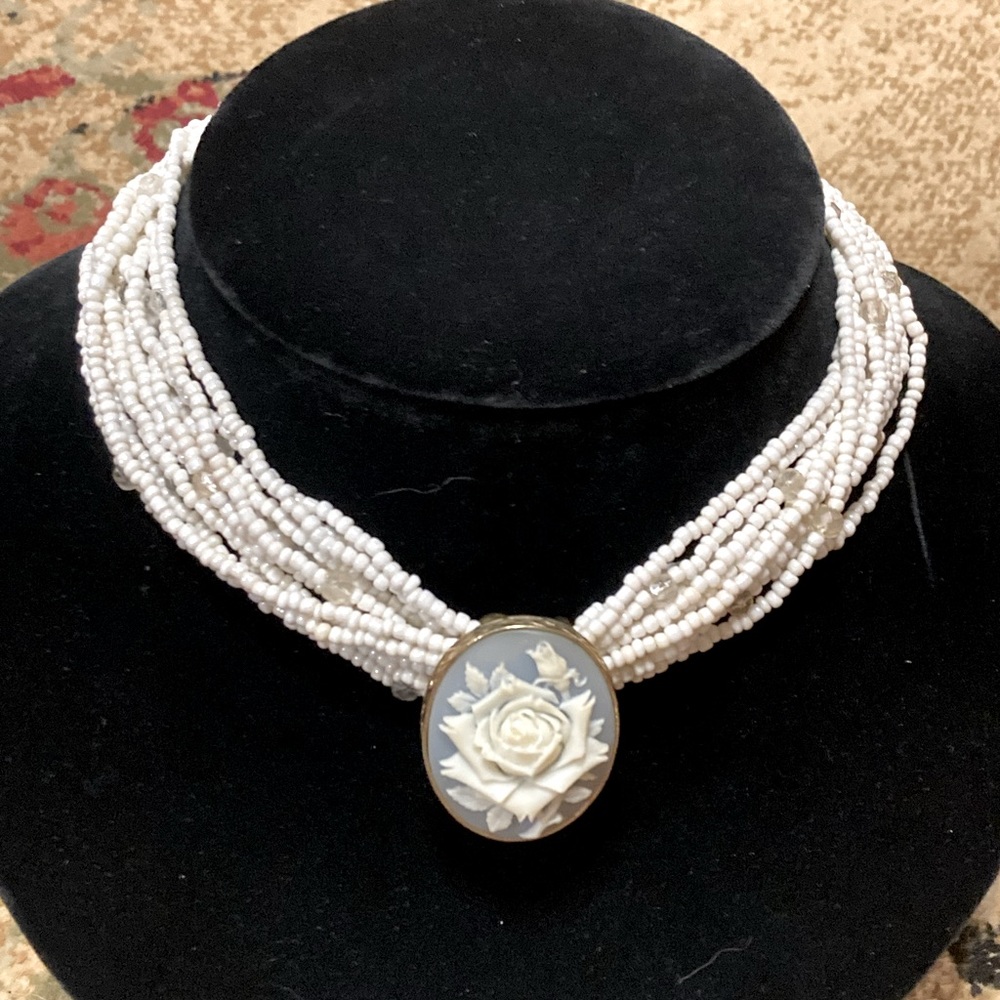 Multi strand pearl choker featuring gorgeous blue floral pendant